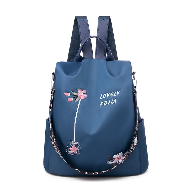 Blumenbestickter Rucksack für Frauen in Blau mit weißem Hintergrund